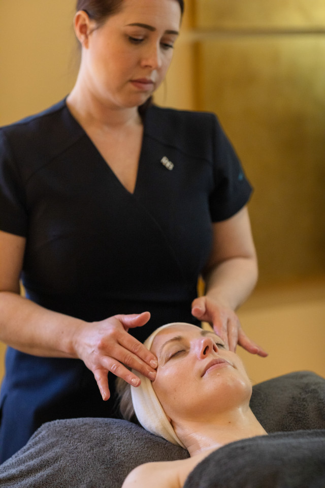 person getting spa treatment at hotel 
