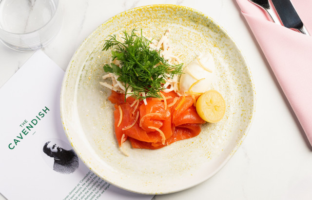 salmon dish served with herbs and lemon
