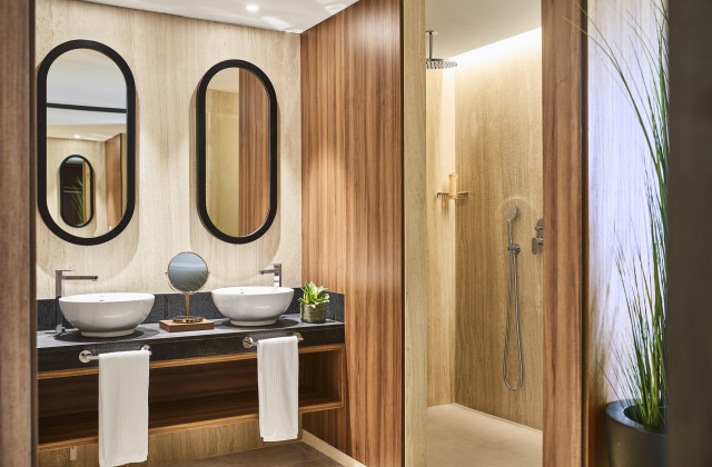 hotel bathroom with wooden walls and two sinks
